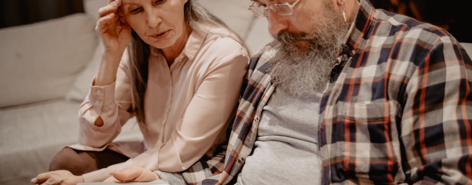 A New Mexico couple reading a letter about their Presbyterian Medicare Advantage plan ending for 2027